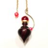 PENDULE ISIS EN BOIS PRECIEUX, LAITON ET SPHERE DE CRISTAL ROUGE